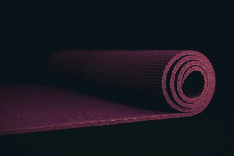 a rolled yoga mat sitting in the dark