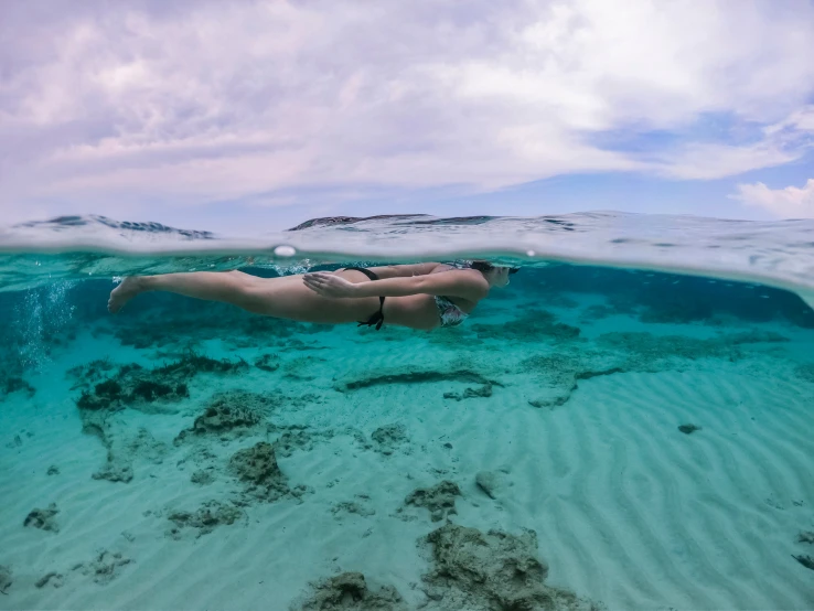 a women in bikini in shallow water with bubbles