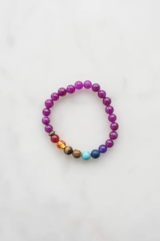 multi colored beads on a white surface with spacers