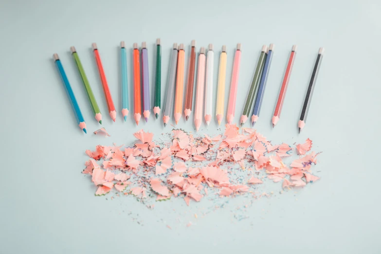 a table filled with different colored and small pencils