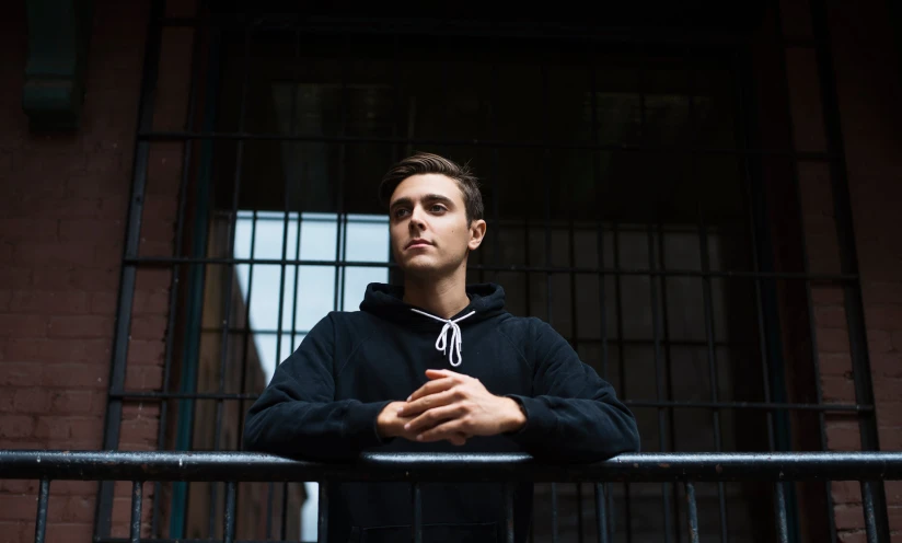 the young man is posing with his arms crossed