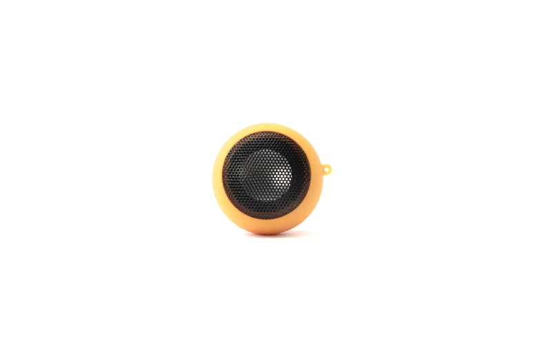 an orange speaker sitting on top of a white table