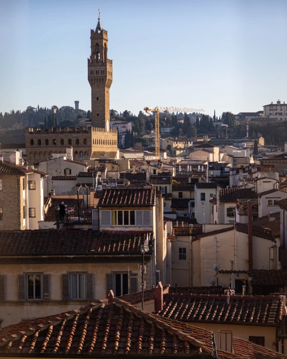 an old church steeple rising above city skyline