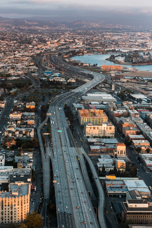 aerial view of city with overhead car traffic and long roadway