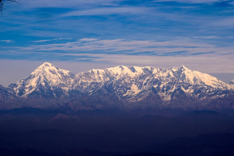 a snow capped mountain side on a clear day