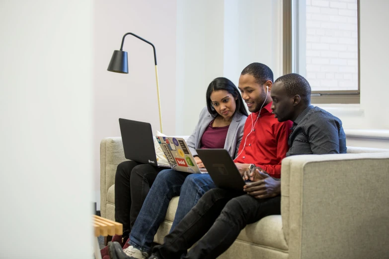 three s using a laptop in an apartment