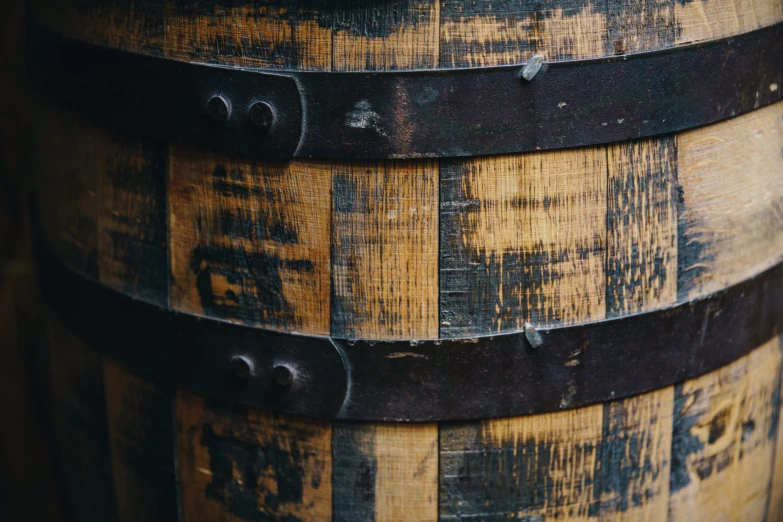 several dark and yellow barrels with wooden lids