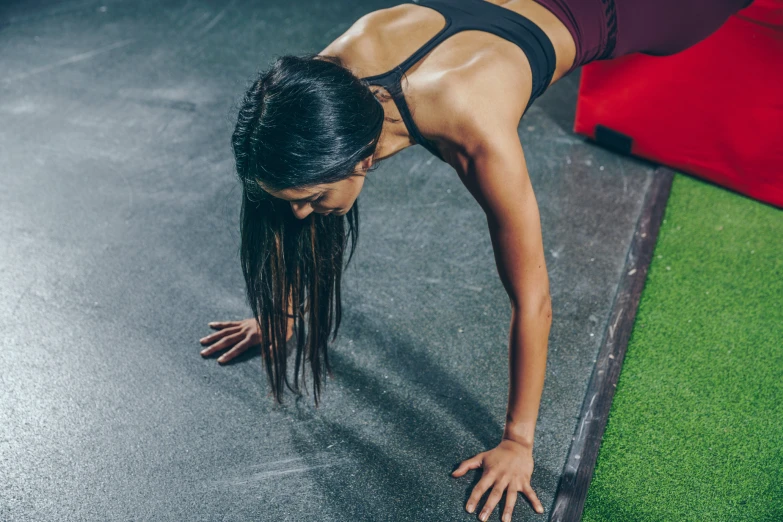 the girl is doing a yoga trick on the floor