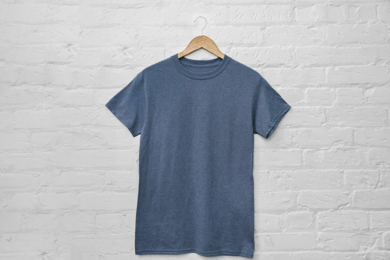 a blue t - shirt hanging on a brick wall