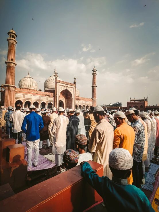 group of men in muslim garb gathered on roof top