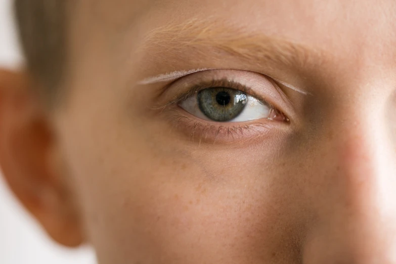 the eyes and shoulders of a child with brown eyes