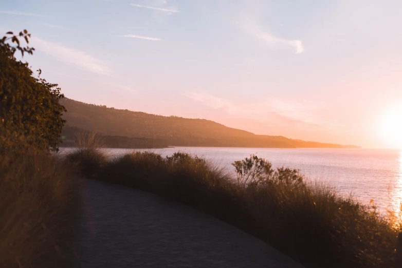 a picture of a person riding a bench near the water