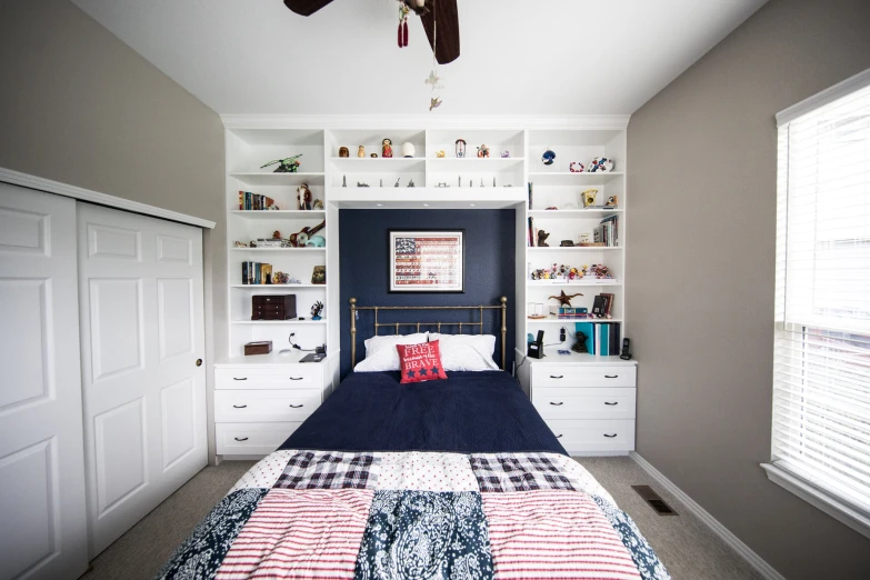 a bedroom with a bed, shelfs and pillows