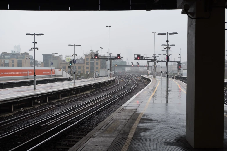 train tracks running through a town near an elevated station