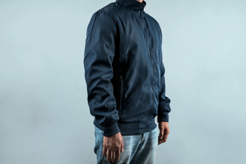 man in black jacket with grey hair looking down