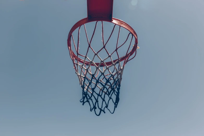 a red basketball hoop and a blue sky