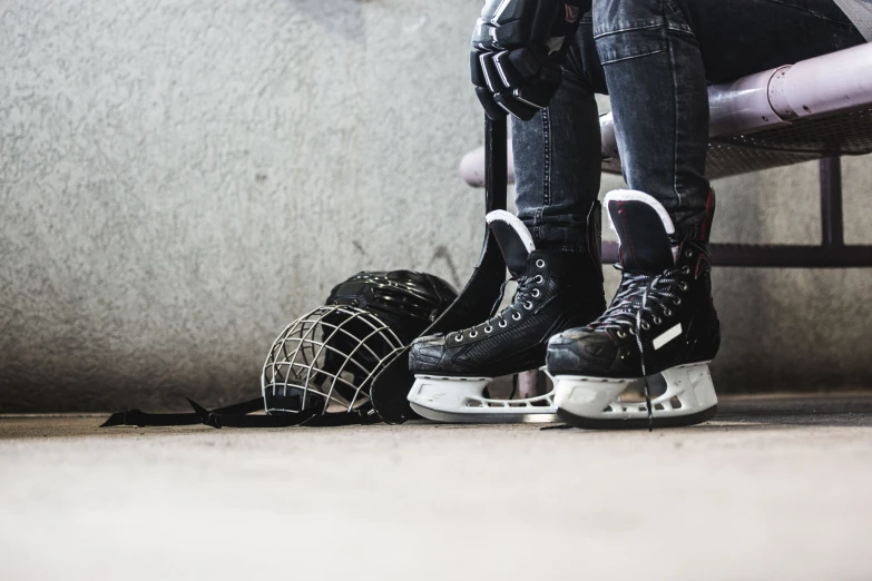 two black and white sneakers, one with their skis on