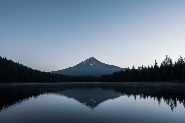 a lone boat floats in a still lake