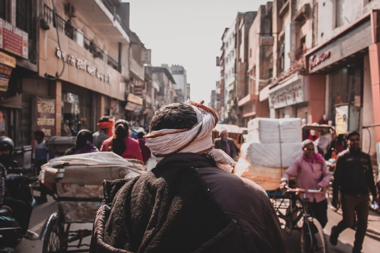 people walking down a crowded street with lots of bicycles