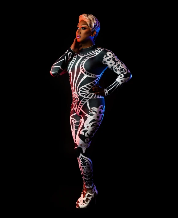 a woman with white hair is wearing a bodysuit and posing