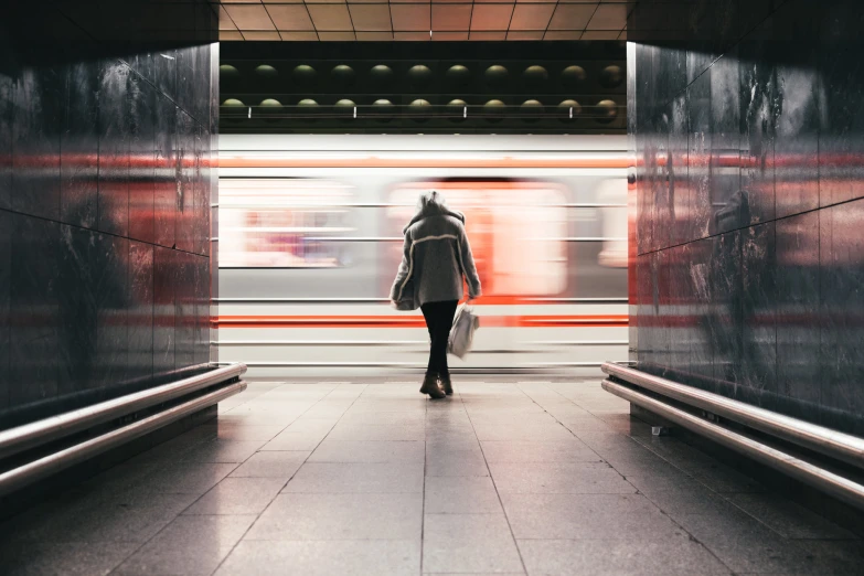 a woman waiting for a train to pass by