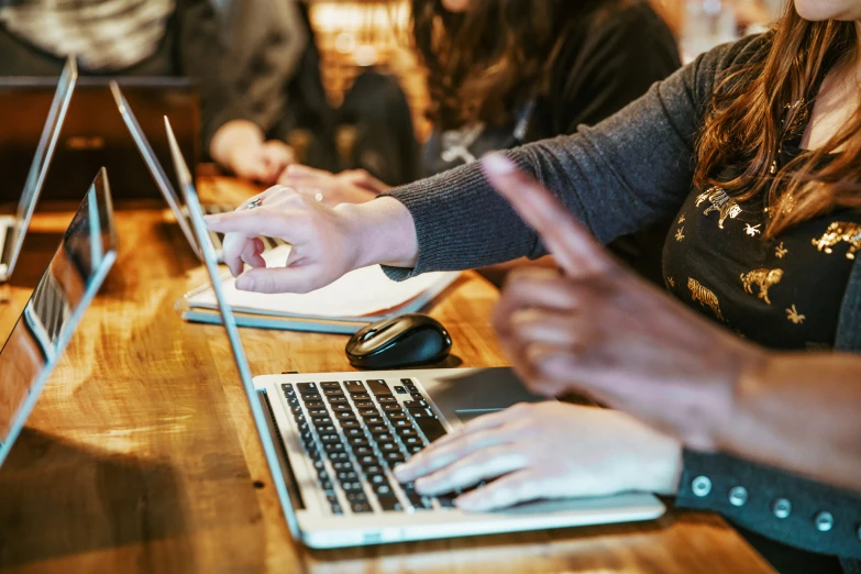 people using laptop computers on tables at a conference