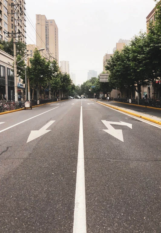 an empty street with two arrows painted on it