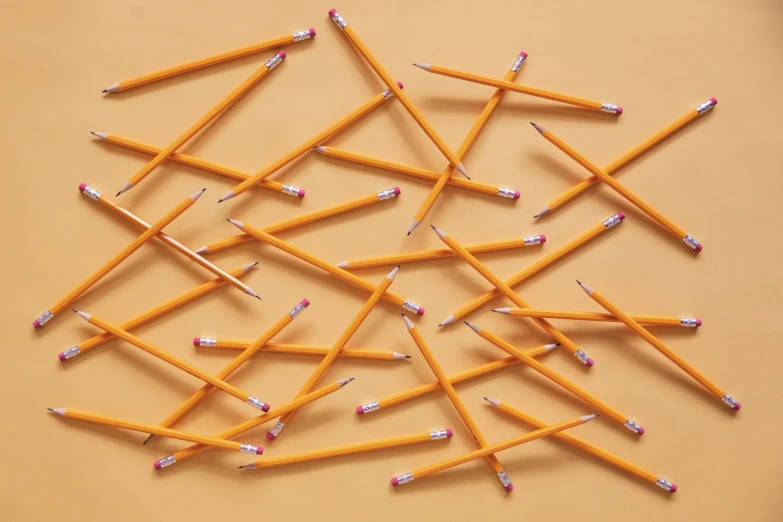 the many rows of pencils are arranged on the surface