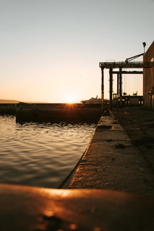 a dock at a lake that has boats and equipment on it