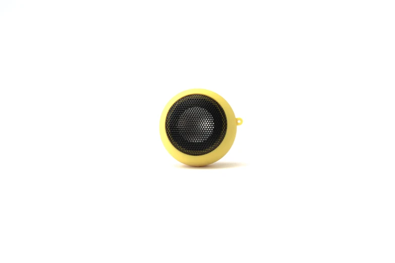 the yellow speaker is placed close to a white background