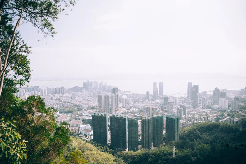 a large city in the distance from a hill