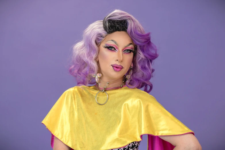 a woman with crazy make - up wearing a yellow blouse