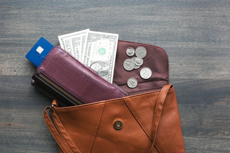 purse with coins and a wallet sitting inside