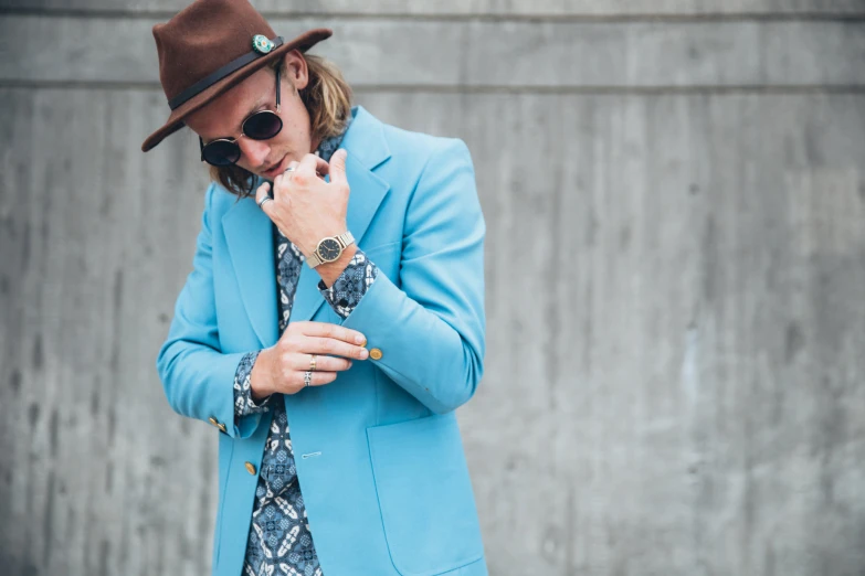 a man wearing blue coat and hat on the phone