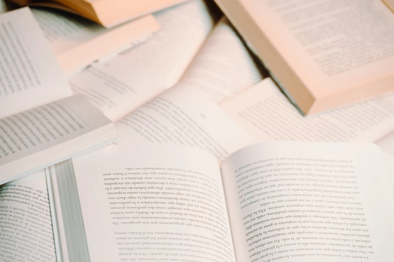 a bunch of open books sitting on top of each other