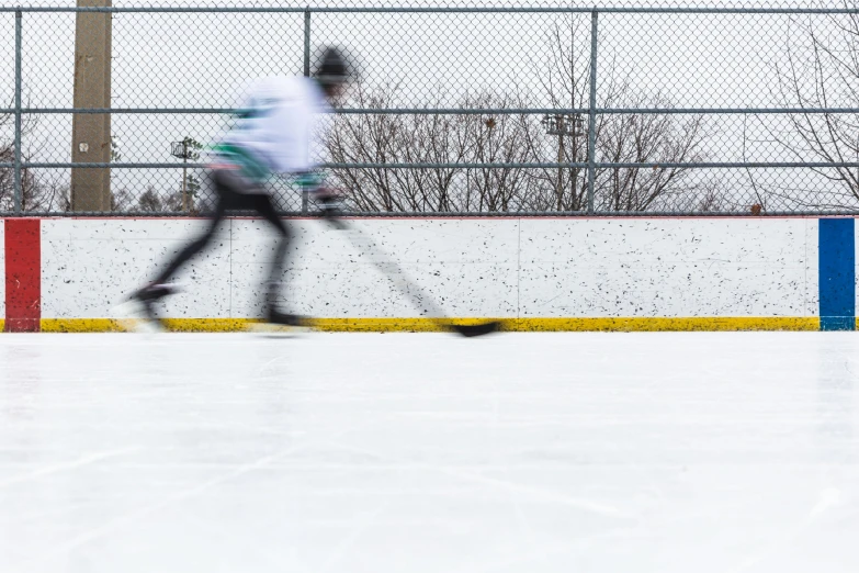 two people skating on an ice rink in the winter