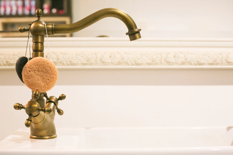 a sink with a faucet hanging over it