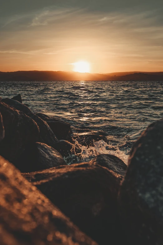 sunset at the end of an ocean shore line