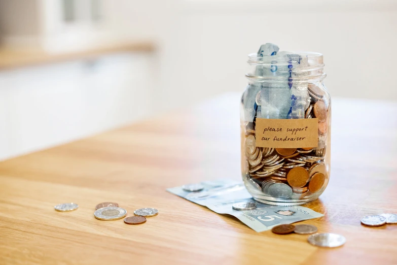 a money jar filled with different types of coins