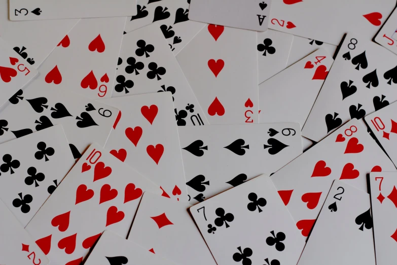 poker playing cards stacked up on a table