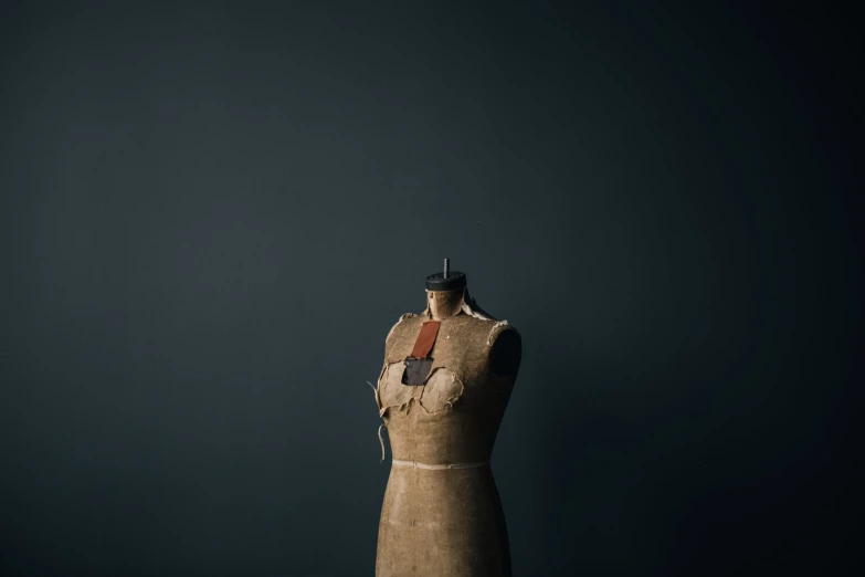 a mannequin is holding a red piece of fabric