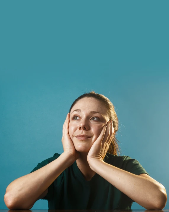 a woman sits at a table posing for a picture