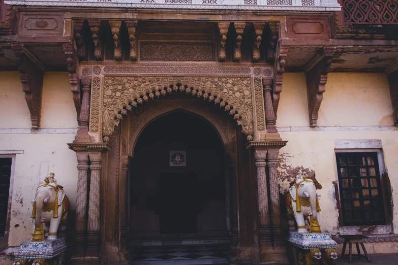 a statue on a platform next to an ornate building