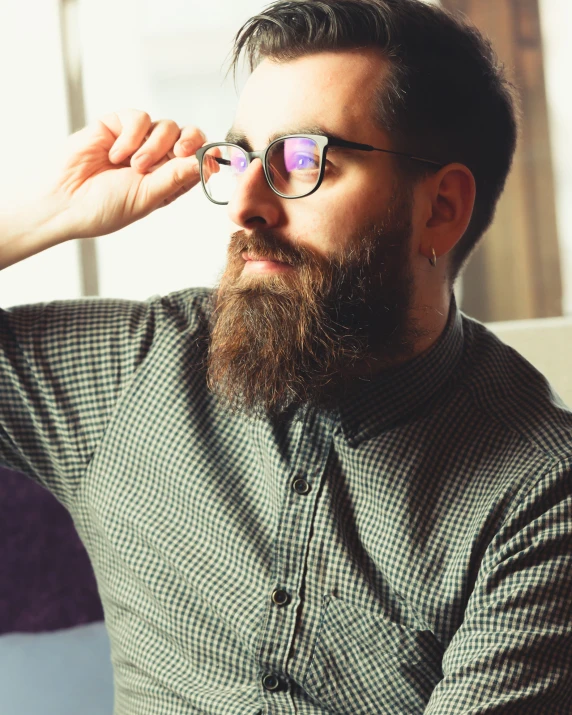 a man with a long beard wearing glasses