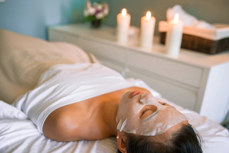 a woman is getting spa treatment on her head