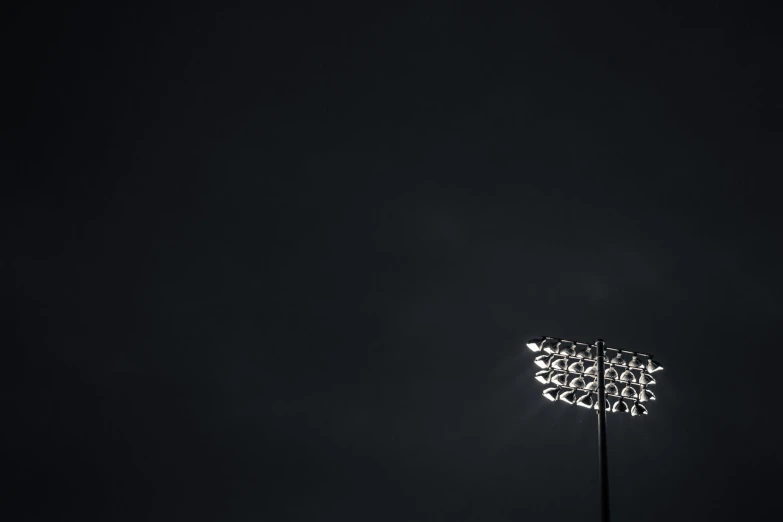 a view of a baseball field with no grass and the dark background