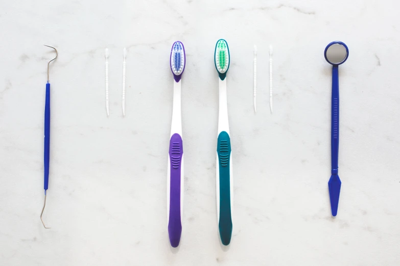 toothbrushes are lined up on a counter top