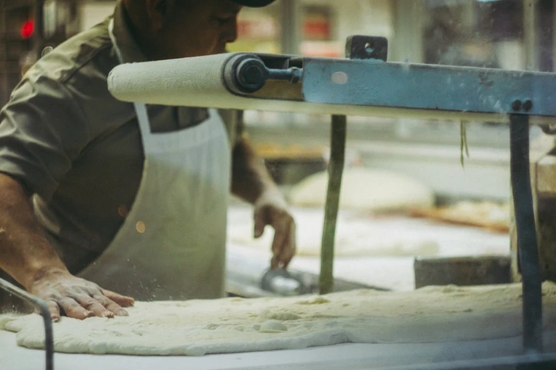 a chef is making dough on a table