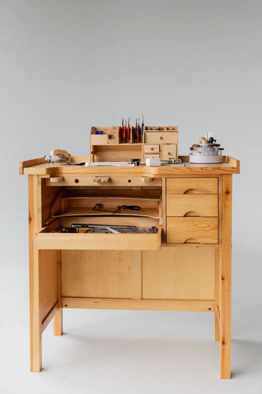 a wooden workbench with multiple compartments and drawers