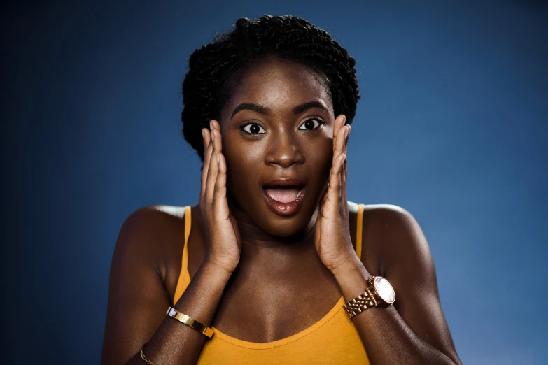 a woman holds her hands near her face